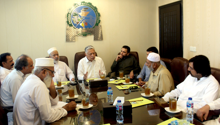 SCCI President Fuad Ishaq (centre), Tajir Ittehad Khyber Pakhtunkhwa President Mujeeb Ur Rehman (centre to 2nd left) and other persons are there seen in this image. — Facebook/@sarhadchamber/file