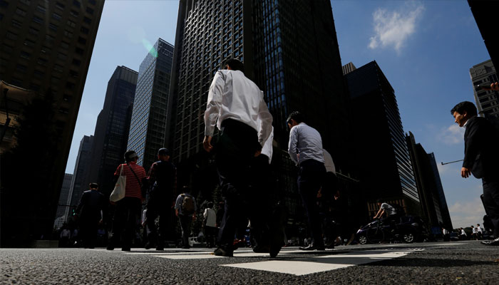 People walk on a crosswalk at a business district in central Tokyo, Japan September 29, 2017. — Reuters