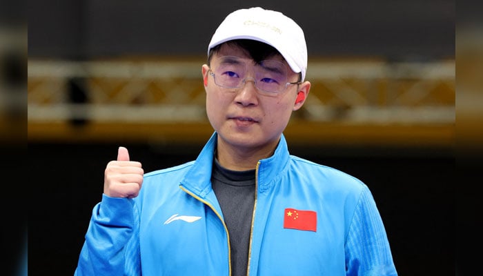 Chinas gold medallist Li Yuehong celebrates after the 25m Rapid Fire Pistol mens Final during the Paris 2024 Olympic Games at Chateauroux Shooting Centre on August 5, 2024. — AFP