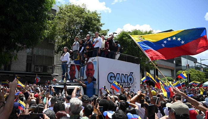 Venezuelan opposition leader Maria Corina Machado sings the national anthem during a demonstration to protest over the presidential election results, in Caracas on August 3, 2024. — AFP