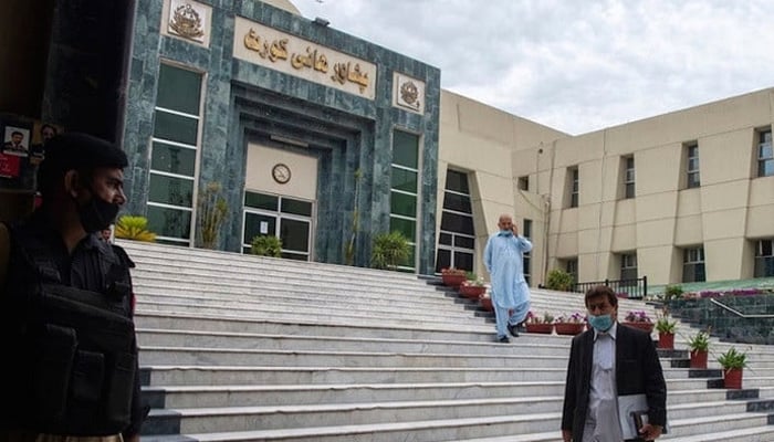 A lawyer walks past in front of the Peshawar High Court building.—AFP/File