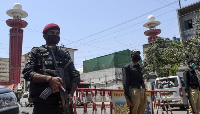 Sindh police personnel standing guard on a street. — AFP/File