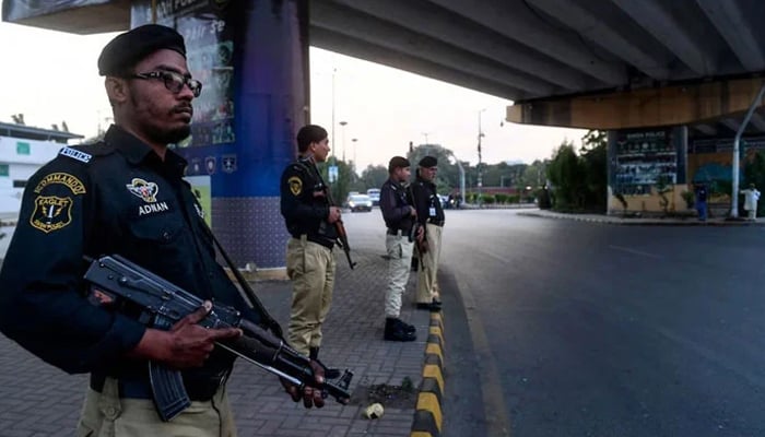 Police personnel can be seen standing guard in Karachi. — AFP/File