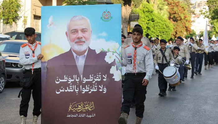 Members of Imam al-Mahdi scouts carry a picture depicting late Hamas leader Ismail Haniyeh, during a protest condemning his killing, in Sidon, Lebanon on August 5, 2024. — Reuters