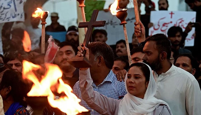 Representational image shows Christians holding a torchlight rally in Karachi on August 19, 2023, to condemn the attacks on churches in Pakistan. — AFP/File