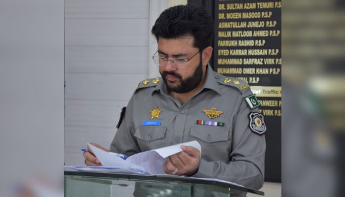 The Chief Traffic Officer (CTO) Islamabad Muhammad Sarfraz Virk looks into papers during the established orderly room on August 8, 2024. — Facebook/Islamabad Police