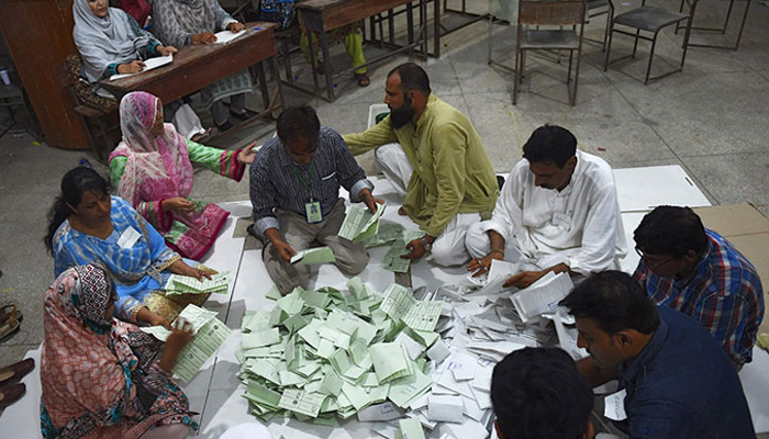 A representational image showing ECP officials counting votes at a polling station in Karachi.. — AFP/File