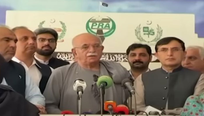 Tehreek Tahaffuz Aiyeen-e-Pakistan head Mehmood Khan Achakzai (centre) speaks to the media alongside PTI leaders outside National Assembly in Islamabad on August 9, 2024. — Screengrab via Geo News