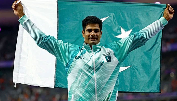 Arshad Nadeem poses with the national flag after winning the gold medal in the Mens Javelin Throw final event in Paris Olympics 2024 at Stade de France, Saint-Denis, France on August 08, 2024. — Reuters