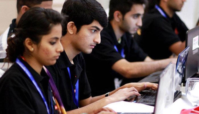 Young Pakistan students seen working on their laptops.— The News/file