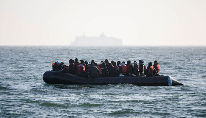 Migrants wait for help from the Abeille Languedoc ship after their boats generator broke down in French waters while they were trying to cross the Channel illegally to Britain, off the coasts of Boulogne-sur-Mer, northern France, on May 9, 2022. — AFP