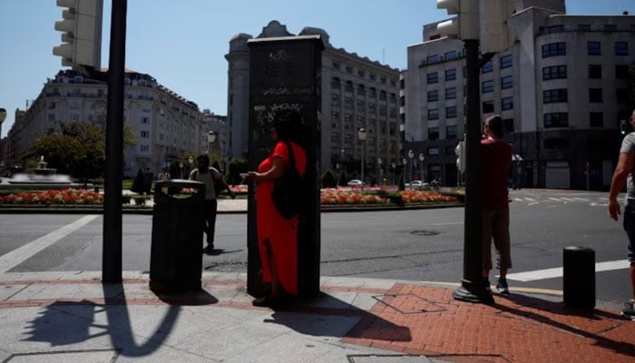 A woman seeks shade in Bilbao, Spain on  August 11, 2024. — Reuters