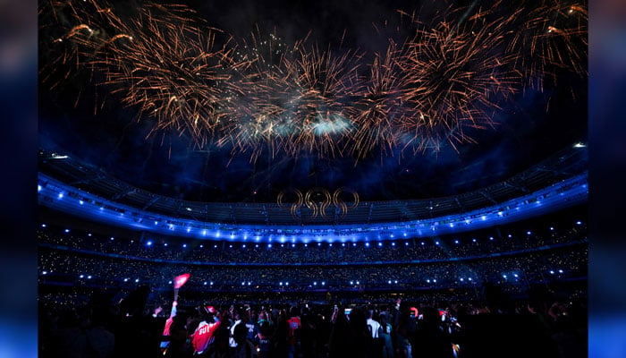 Fireworks sparkle behind the Olympic Rings in the sky at the end of the closing ceremony of the Paris 2024 Olympic Games in the outskirts of Paris, on August 11, 2024. — AFP