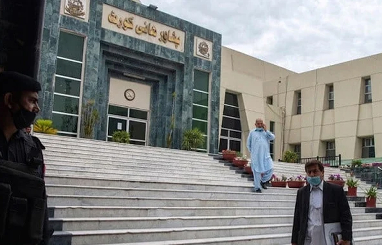 A lawyer walks past in front of the Peshawar High Court building.—AFP/File