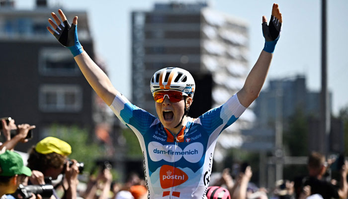 Dutch rider Charlotte Kool celebrates as she crosses the finish line to win the first stage (out of 8) of the third edition of the Womens Tour de France cycling race a 123 km individual time trial between Rotterdam and The Hague, on August 12, 2024. — AFP