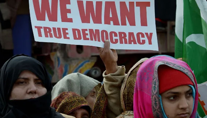 Women hold placards in protest. — AFP/File