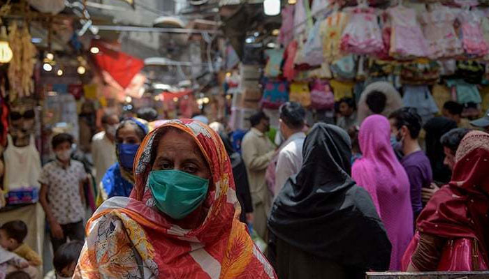 A representational image showing people at a busy market. — AFP/File