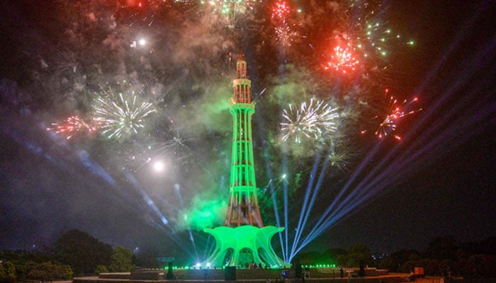 People watch fireworks explode overnight at the Minar-e-Pakistan on the eve of the Independence Day, in Lahore on August 13, 2024. — AFP