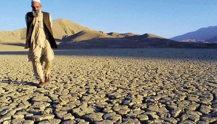 The representational image shows a man walking on the dried, cracked landscape near Hanna Lake in Quetta, Pakistan. — AFP/File