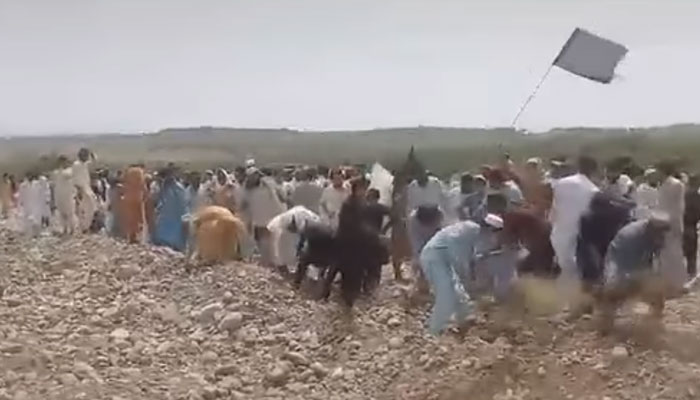 A Screengrab taken on 15, 2024, shows protestors uprooting the gas pipeline in North Waziristan. —  Ftacbook/M Tariq Raza