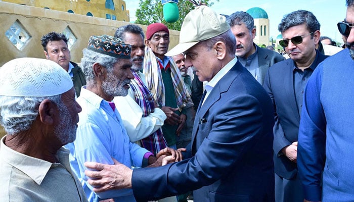 Prime Minister Muhammad Shehbaz Sharif consoling the affectees of torrential rains at a relief camp on March 5, 2024. — APP