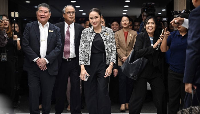 Puea Thai Party leader Paetongtarn Shinawatra (C), the youngest daughter of former PM Thaksin Shinawatra, leaves a press conference with coalition party leaders after being named the candidate to be Thailands next prime minister at Shinawatra Tower in Bangkok on August 15, 2024. — AFP