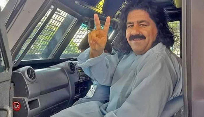 Former MNA Ali Wazir gestures for a photo while being in polices custody in this undated image. — Facebook/Ali Wazir/File