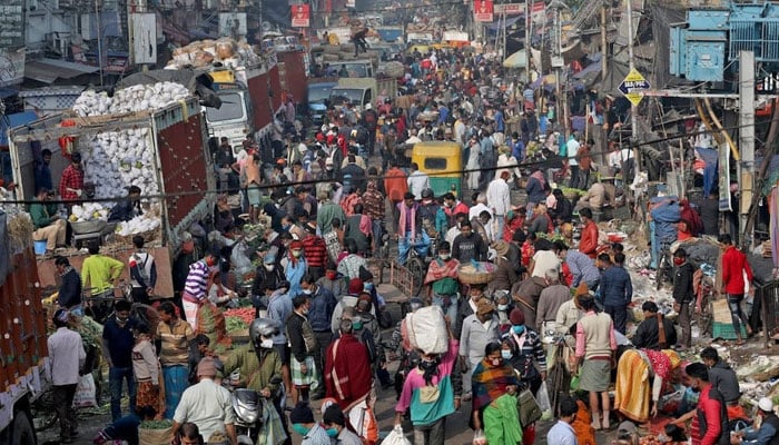 People walk in a busy street at a local market in Karachi. — PPI/File