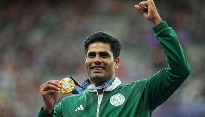 Arshad Nadeem gestures with his gold medal after winning mens javelin throw event at Paris Olympics on August 9, 2024. — Reuters