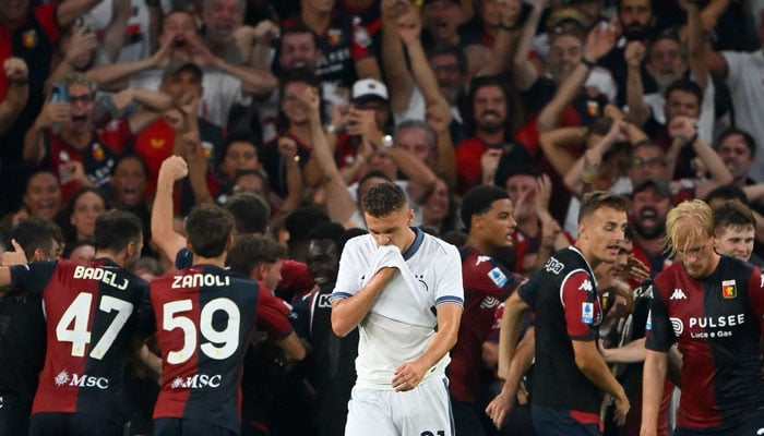 Inter Milans Albanian midfielder #21 Kristjan Asllani (C) reacts as Genoas Brazilian forward #10 Messias celebrates after scoring his teams second goal during the Italian Serie A football match between Genoa and Inter Milan in Genoa, on August 17, 2024. — AFP