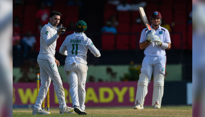 Keshav Maharaj (L) of South Africa celebrates the dismissal of Joshua Da Silva (R) of West Indies during Day 3 of the 2nd Test match between West Indies and South Africa in Providence, Guyana, on August 17, 2024. — AFP