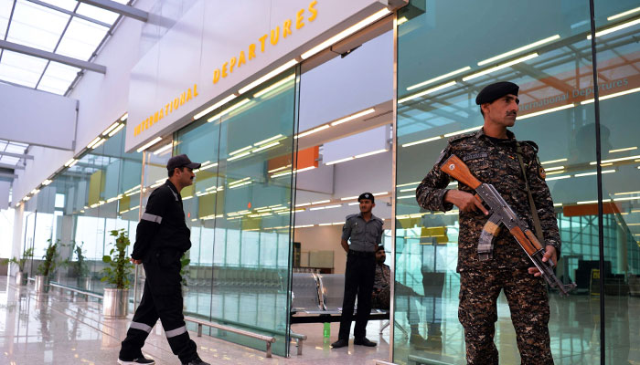 A representational image showing ASF personnel standing guard at international departure gate of an airport. — AFP/File