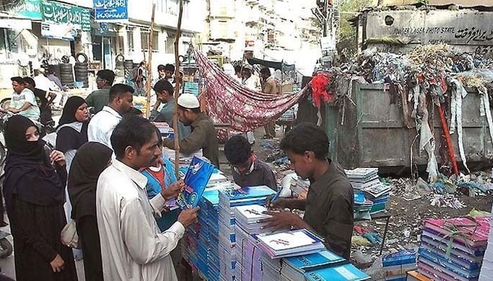 A representational image showing vendors selling books at a stall. — AFP/File