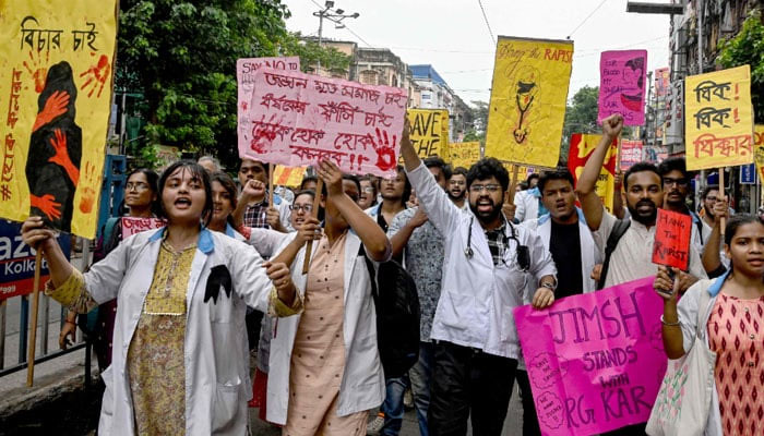 Activists and medical professionals shout slogans and hold posters during a protest to condemn the rape and murder of a young medic in Kolkata on August 12, 2024. — AFP