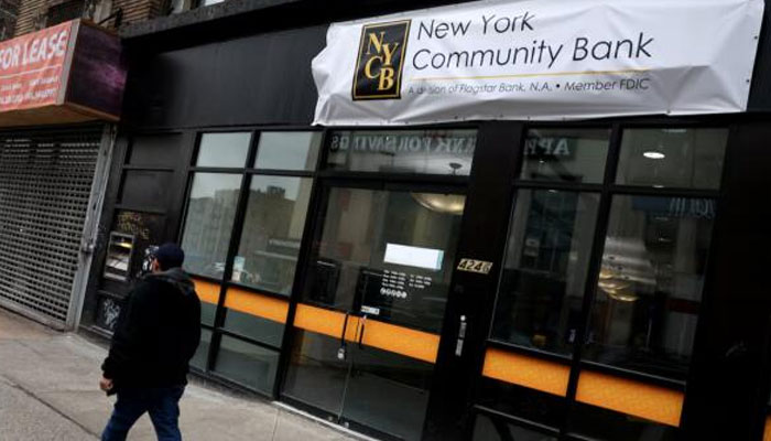 A man walks past a closed branch of the New York Community Bank in New York City. — Reuters/file