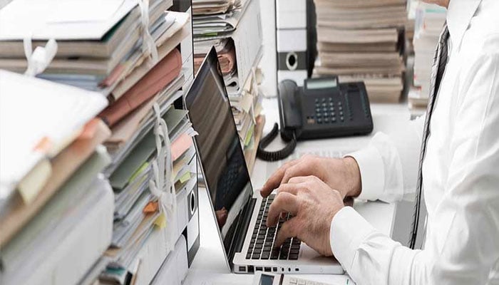 A representational image of a man working in an office.— The News/file