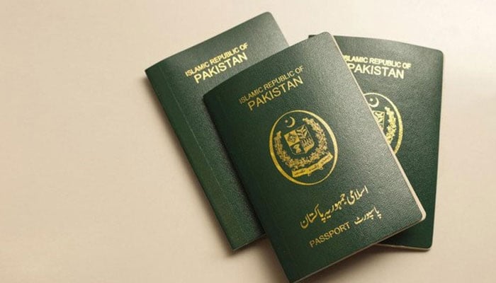 This representative image shows three books containing Pakistani passports. — AFP/File