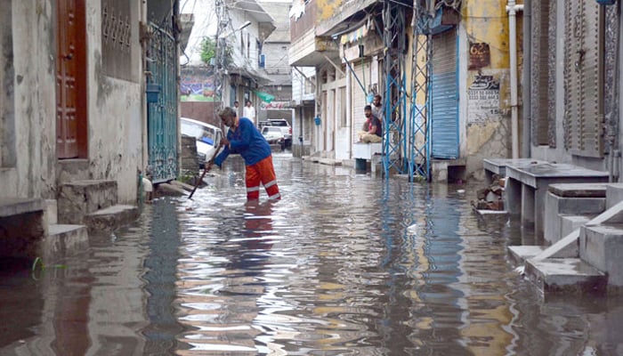 A resident throwing rain water accumulated in his house at Dhok Illahi Baksh after the heavy rain in morning hours in Rawalpindi on July 12, 2024. — Online