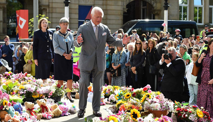 Britains King Charles III reacts as he views tributes outside Southport Town Hall, during his visit to meet with members of the local community, following the July 29 attack at a childrens dance party, in Southport, northwest England, on August 20, 2024. — AFP