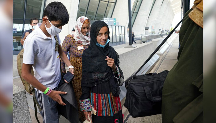 Afghan refugees board a bus taking them to a processing centre upon their arrival at Dulles International Airport in Dulles, Virginia, U.S. on August 26, 2021. — Reuters