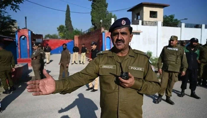 Police officials stand guard outside the Adiala Jail in Rawalpindi on October 23, 2023. — AFP