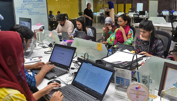 People work at their stations at an incubation center in Lahore. — AFP/File