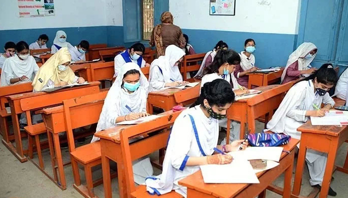 Students solve question papers during their annual examinations. — APP/File