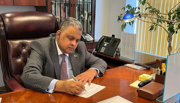 Pakistans newly-appointed Ambassador to the US Rizwan Saeed Sheikh signs a document in this image released on August 22, 2024. — Facebook/Pakistan Embassy US