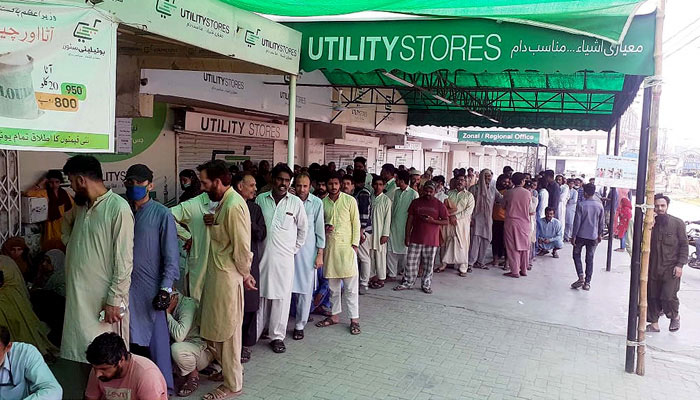 People gather in a queue and wait for their turn to buy edibles at a Utility Stores outlet. — PPI/File