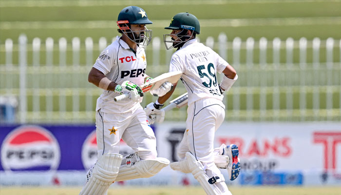 Pakistan´s Mohammad Rizwan (left) and Saud Shakeel run between the wickets during the second day of the first Test cricket match between Pakistan and Bangladesh at the Rawalpindi Cricket Stadium in Rawalpindi on August 22, 2024. — AFP