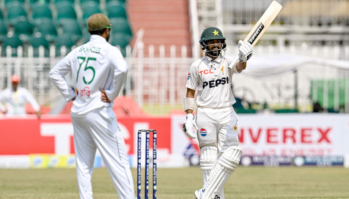 Pakistan´s Saud Shakeel (R) celebrates after scoring a century (100 runs) during the second day of the first Test cricket match between Pakistan and Bangladesh at the Rawalpindi Cricket Stadium in Rawalpindi on August 22, 2024.— AFP