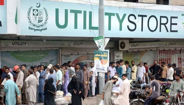 A long queue of people is seen outside a utility store in an undated picture. — APP/File