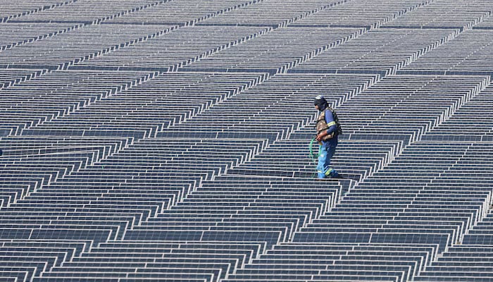 A worker walks at Brazil?s biggest floating solar plant with 10,500 plates on the water surface at the Billings dam developed by Empresa Metropolitana de Aguas e Energia (EMAE) in Sao Paulo, Brazil April 5, 2024. — Reuters