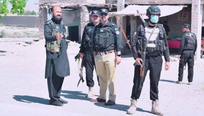 KP police personnel stand guard on the road on May 6, 2024. — Facebook/@BannuPoliceKPK